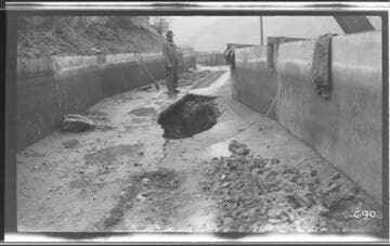 A man standing by the first break in the ditch at Kaweah #3 Hydro Plant
