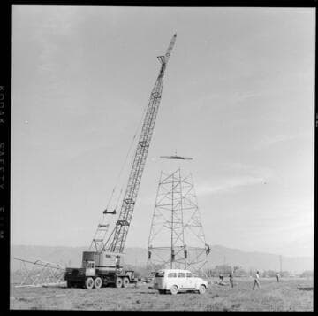 Transmission tower construction using a crane
