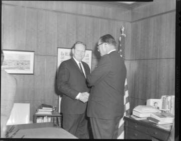 Executives posed exchanging checks