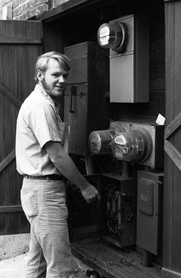 Customer service repairman checking a customers electric meter fuse buss