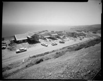 Framework of homes under construction on cliffs overlooking the ocean (Palos Verdes? rel)