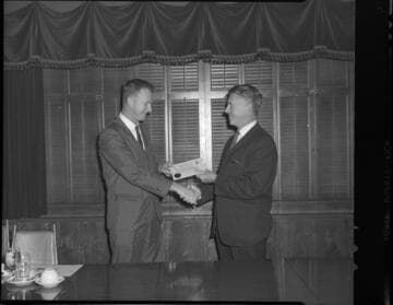 Men receiving Certificates of Completion from Edison's Substation Operators School