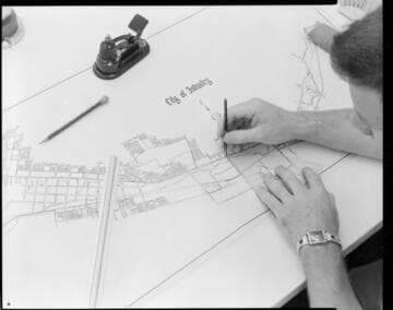 Draftsman drawing plot map for City of Industry