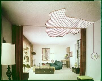 Photo of living room with cutaway ceiling showing radiant heating coils connected to thermostadt color & B&W