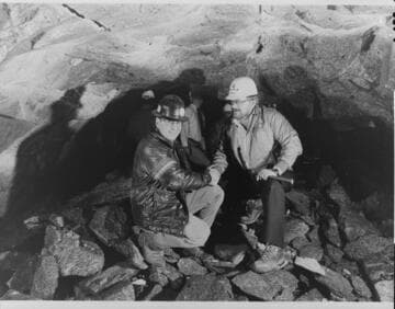 Surrounded by solid granite, 400 feet below the snow-covered Sierra Nevada, SCE's Balsam Meadow Hydroelectric Construction Project Manager, Don Brundage [Bill Emrich?], right, congratulates Dillingham-Atkinson Project Manager, Richard L