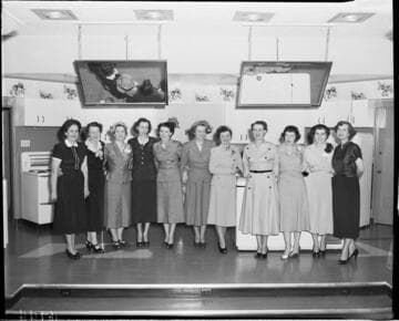 Eleven ladies on stage at cooking class