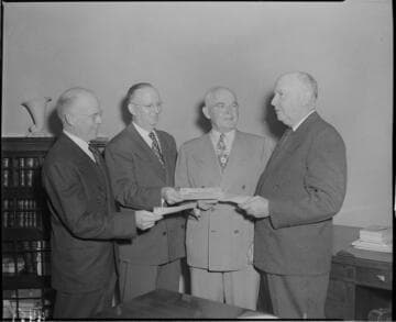 One man receiving checks from three others