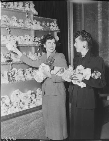 Two ladies with Christmas doll display