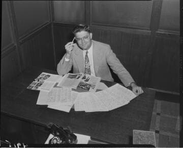 Man at desk with paperwork on football