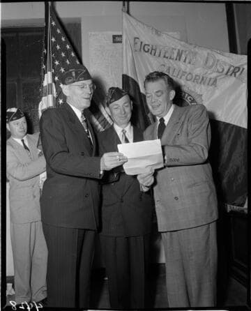 Men looking at document at meeting of American Legion