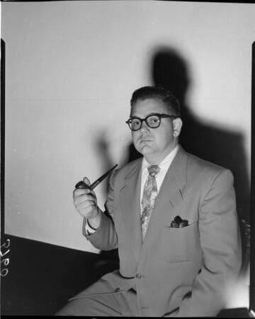 Man with pipe against white backdrop