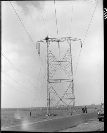 Stringing conductor on transmission towers