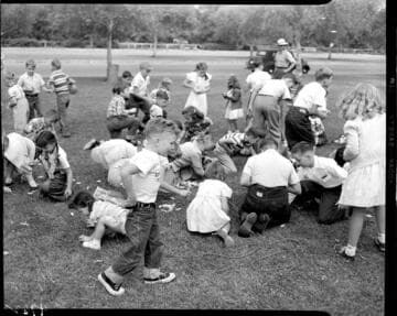 Kids scrambling on grass for goodies