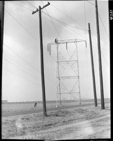 Stringing conductor on transmission towers