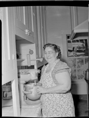 Woman mixing batter in kitchen at Big Creek