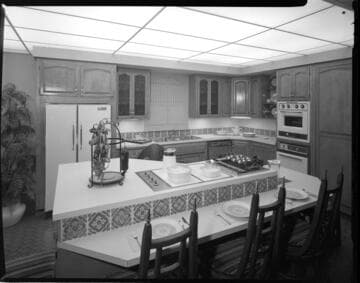 Exhibition booth at a home show showing Alcoa all-electric kitchens and appliances with Corning counter stove tops