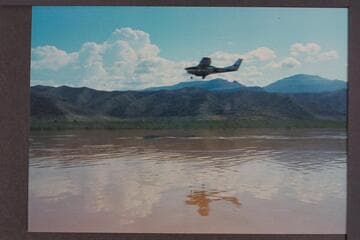 Communication plane to deck boat; Lake Mead above Gods Pocket.  Plane runs close to boat
