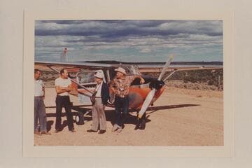 Charter plane at Navajo Mountain Trading Post strip:  the pilot, Ralph Cameron, Dock Marston and Bill Belknap