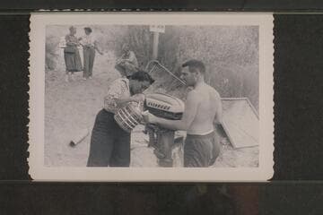 Lodell pours for Garth.  Margaret Marston discusses the situation with Dudy [sic] Thomas.  Dick Sprang sits in the background.  Preparation of boats for cruise of Grand Canyon, Lees Ferry