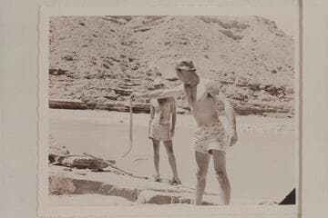 Garth Marston watches Norm Nevills stretch away from a rattler found at the mouth of the Little Colorado River