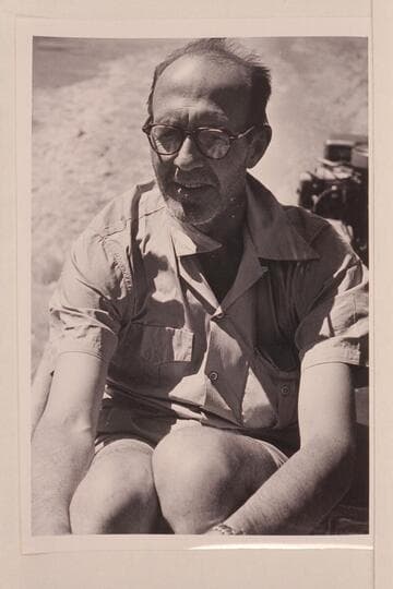John Mull at wheel of Jordan's outboard boat on upper Lake Mead