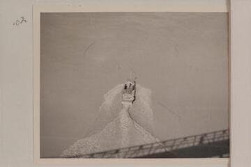 The "Esmeralda II" under the suspension bridge at Bright Angel Creek. The water patterns illustrate the drag which kept the speed so low