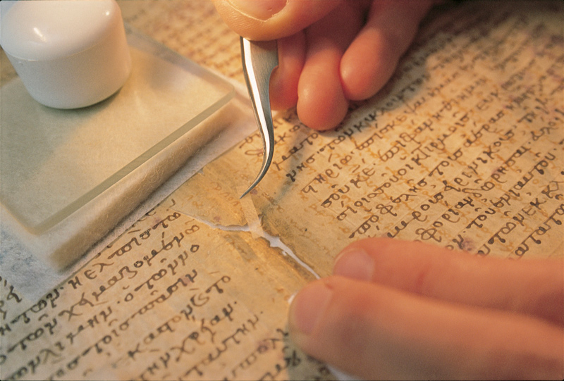 Pictured here, a conservator repairs a tear in a medieval manuscript
known as the Archimedes Palimpsest.